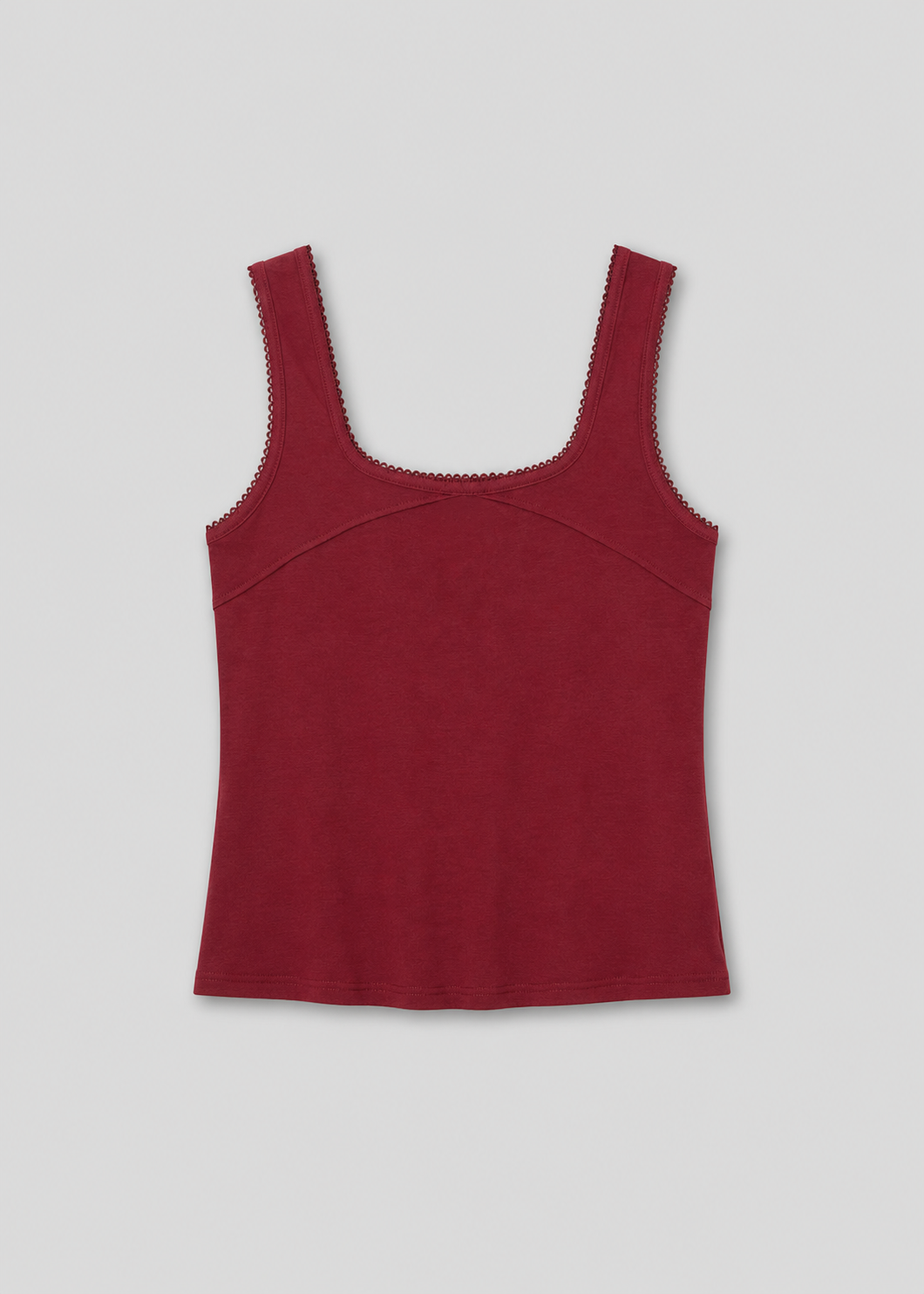 The Piping Tank - Crimson is a sleeveless, square-neckline top in dark red with scalloped trim on the neckline and armholes, shown flat on a light background—a chic style inspired by Deiji Studios.