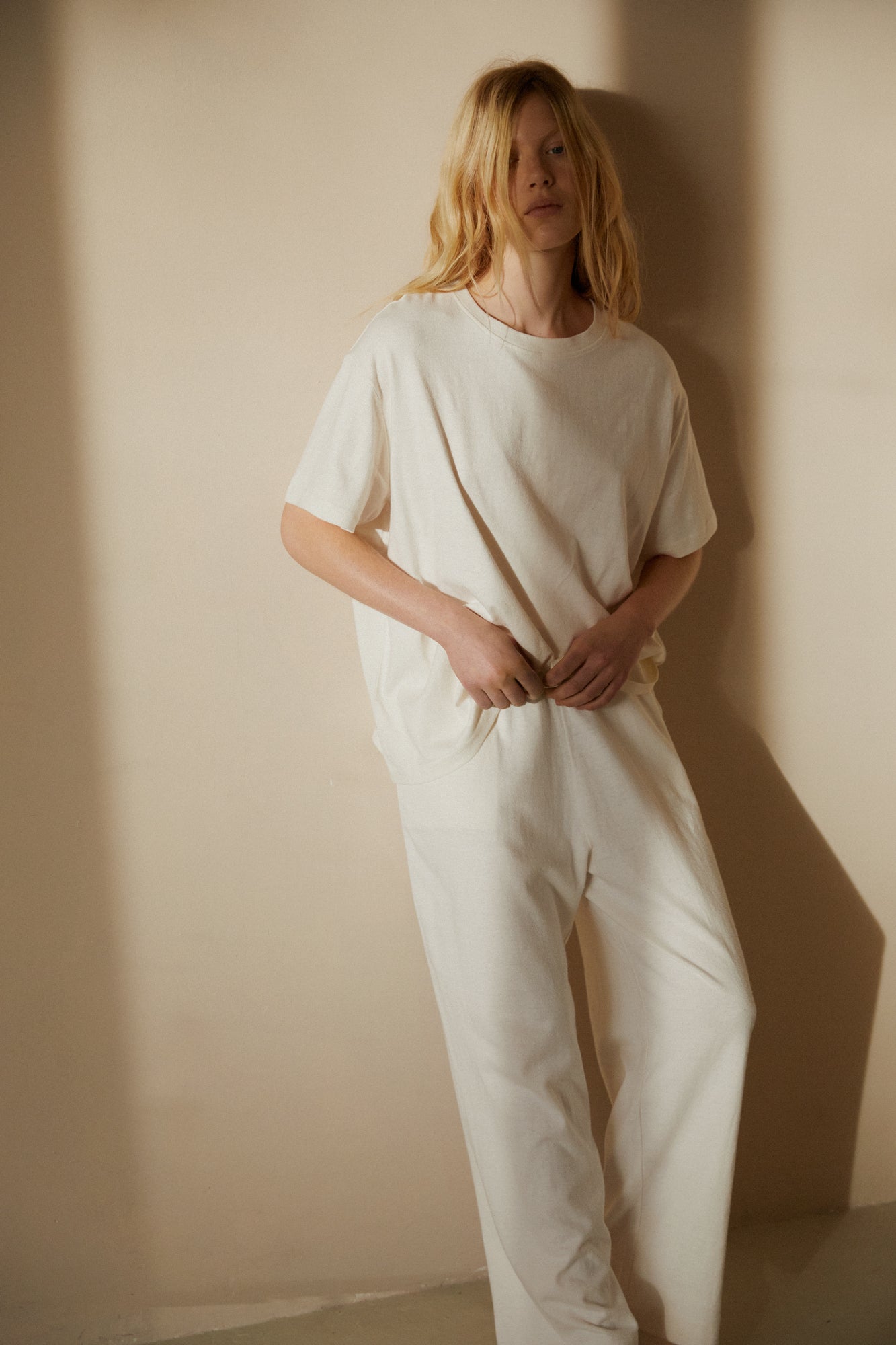 Female model wearing the jersey pant - bone by Deiji Studios against plain background