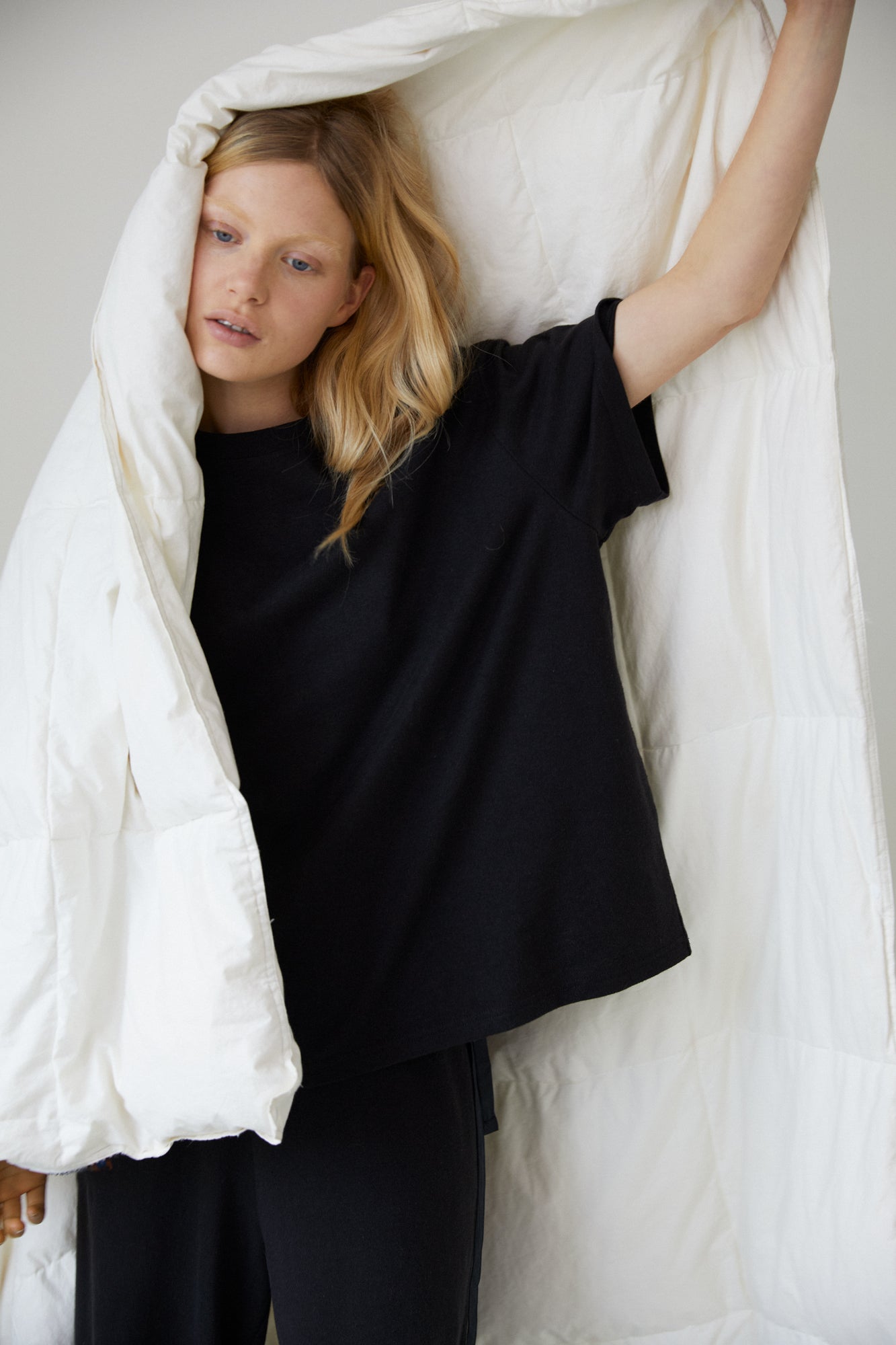Female model wearing the jersey pant - black by Deiji Studios against plain background