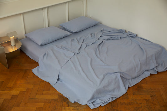 Light room with queen bed topped with Sheets - Cornflower by Deiji Studios