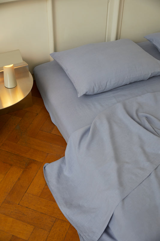 Light room with queen bed topped with Sheets - Cornflower by Deiji Studios