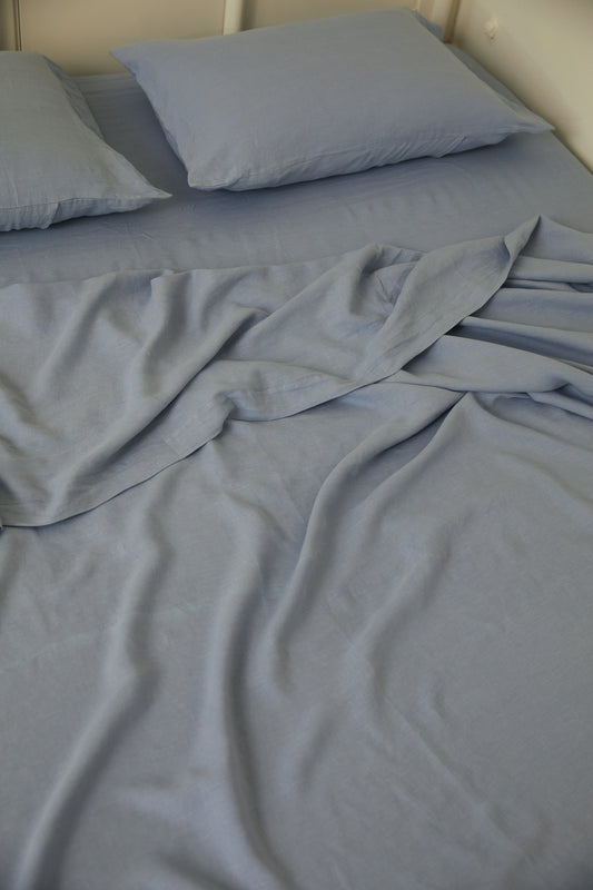 Light room with queen bed topped with Sheets - Cornflower by Deiji Studios