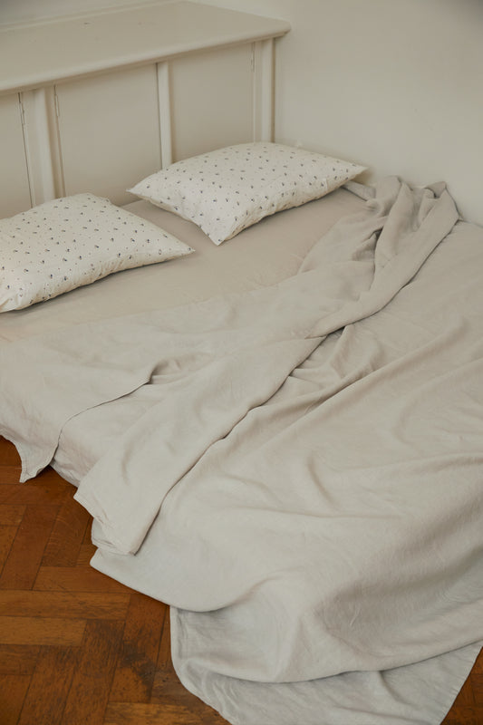 Light room with queen bed topped with Sheets - Oatmeal by Deiji Studios