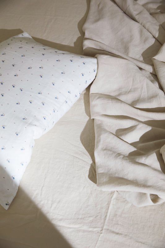 Light room with queen bed topped with Sheets - Oatmeal by Deiji Studios