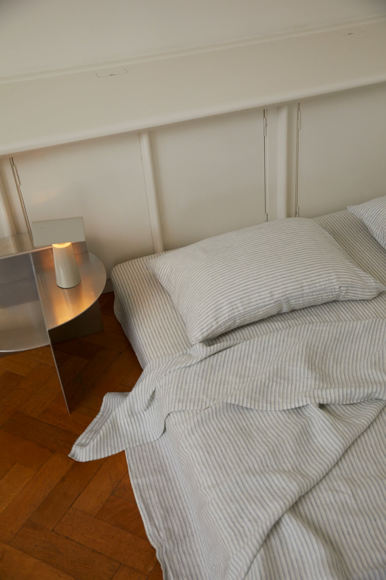 Light room with queen bed topped with Sheets - River Stripe by Deiji Studios