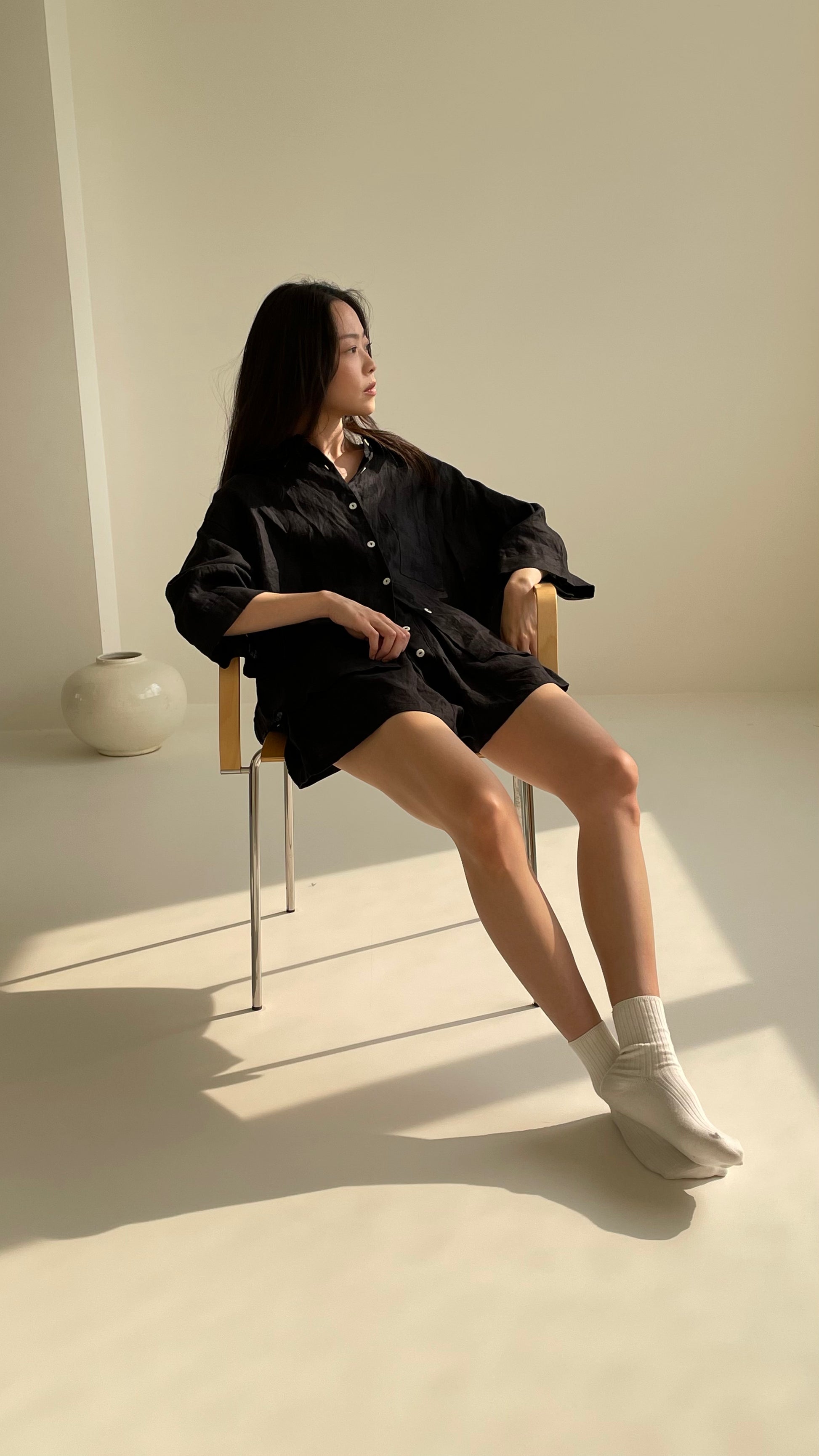 Female model wearing the 03 set - deep black by Deiji Studios against plain background