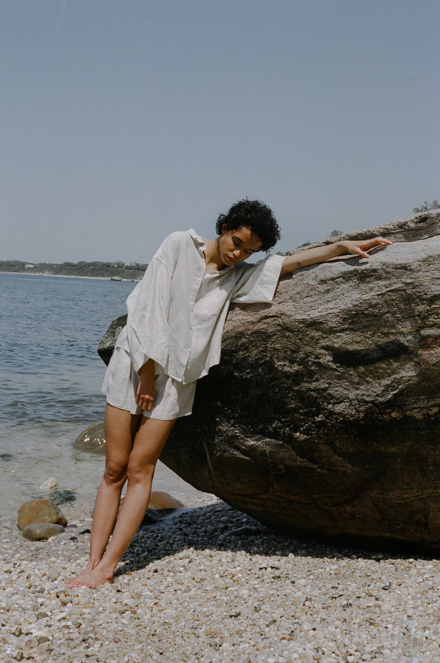 Female model on pebble beach wearing the 03 set - oatmeal by Deiji Studios