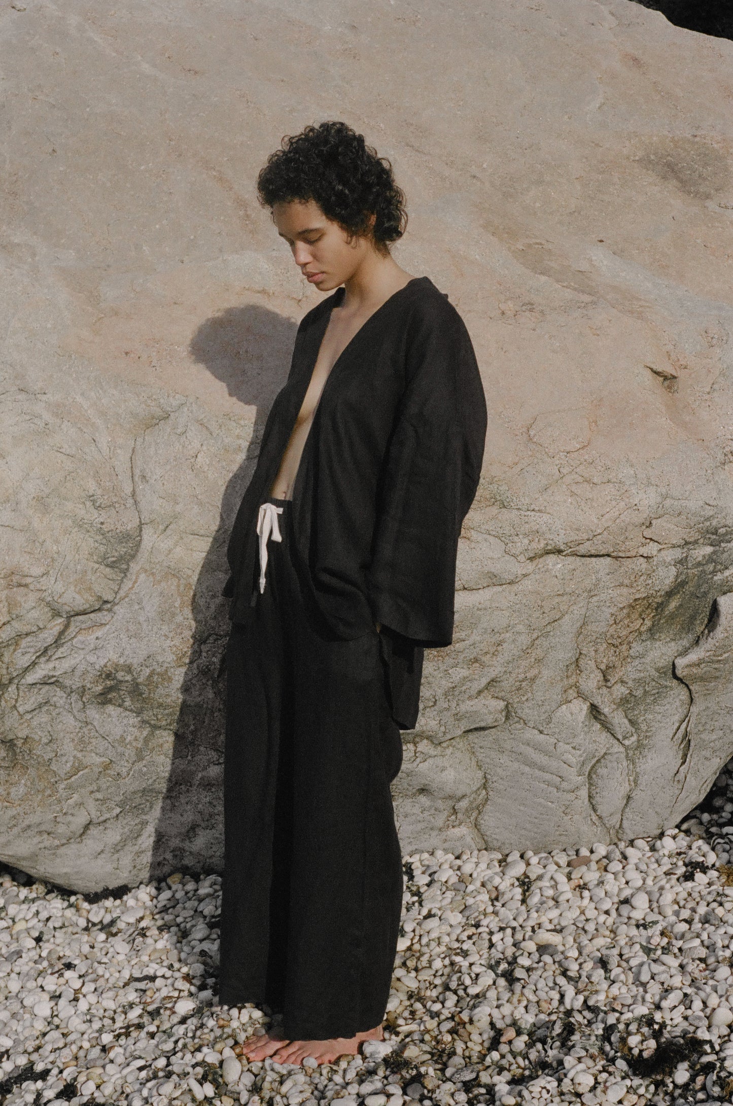 Female model wearing the 01 set - deep black by Deiji Studios against plain background