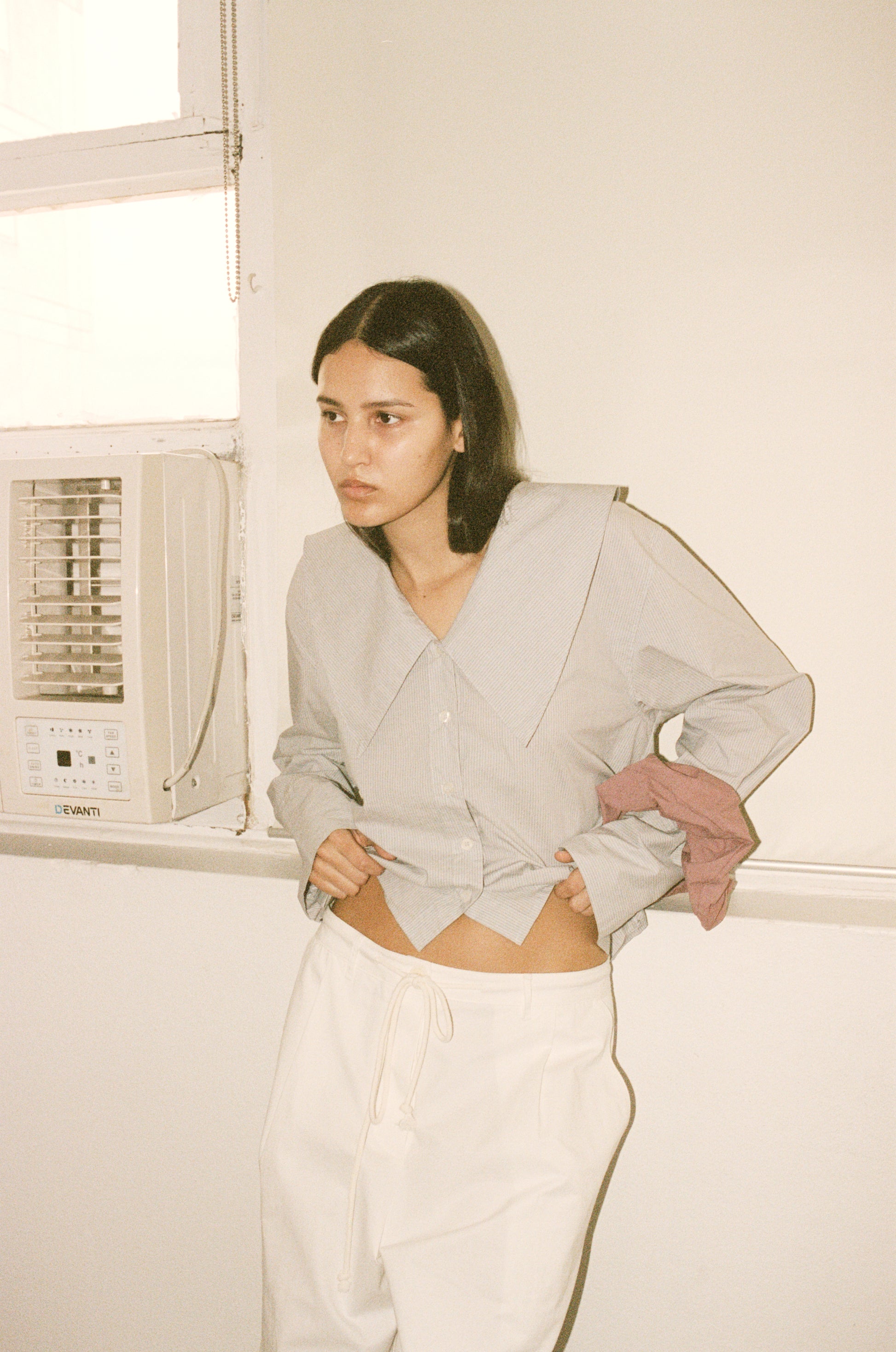 Female model wearing Bartack Pant - Snow - by Deiji Studios against plain background