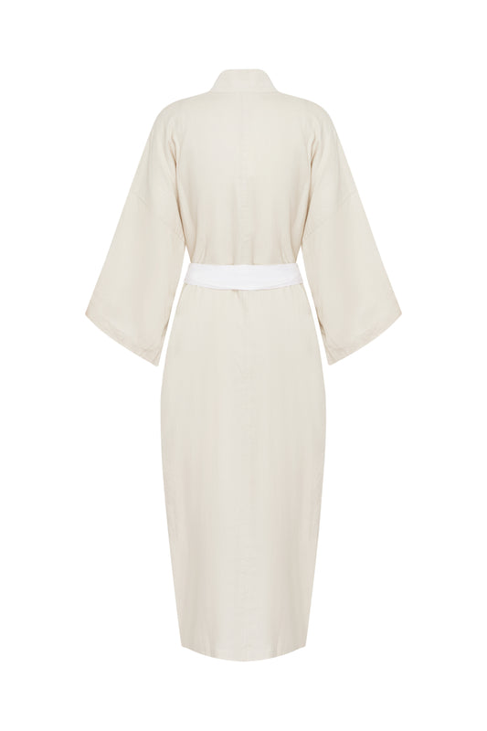 Back view of the 02 robe - oatmeal by Deiji Studios, a light beige, knee-length linen robe with wide sleeves and a white waist tie.