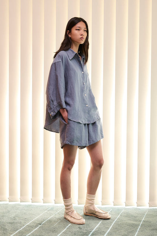 the 03 set by Deiji Studios in air   features an oversized box fit linen shirt with wide arms and a front pocket  designed to sit mid rise, the loose fitting boxer style shorts have a faux button down fly and an elastic waist for extra comfort   made from 100% OEKO-TEX 100 certified and EU certified stone washed french linen