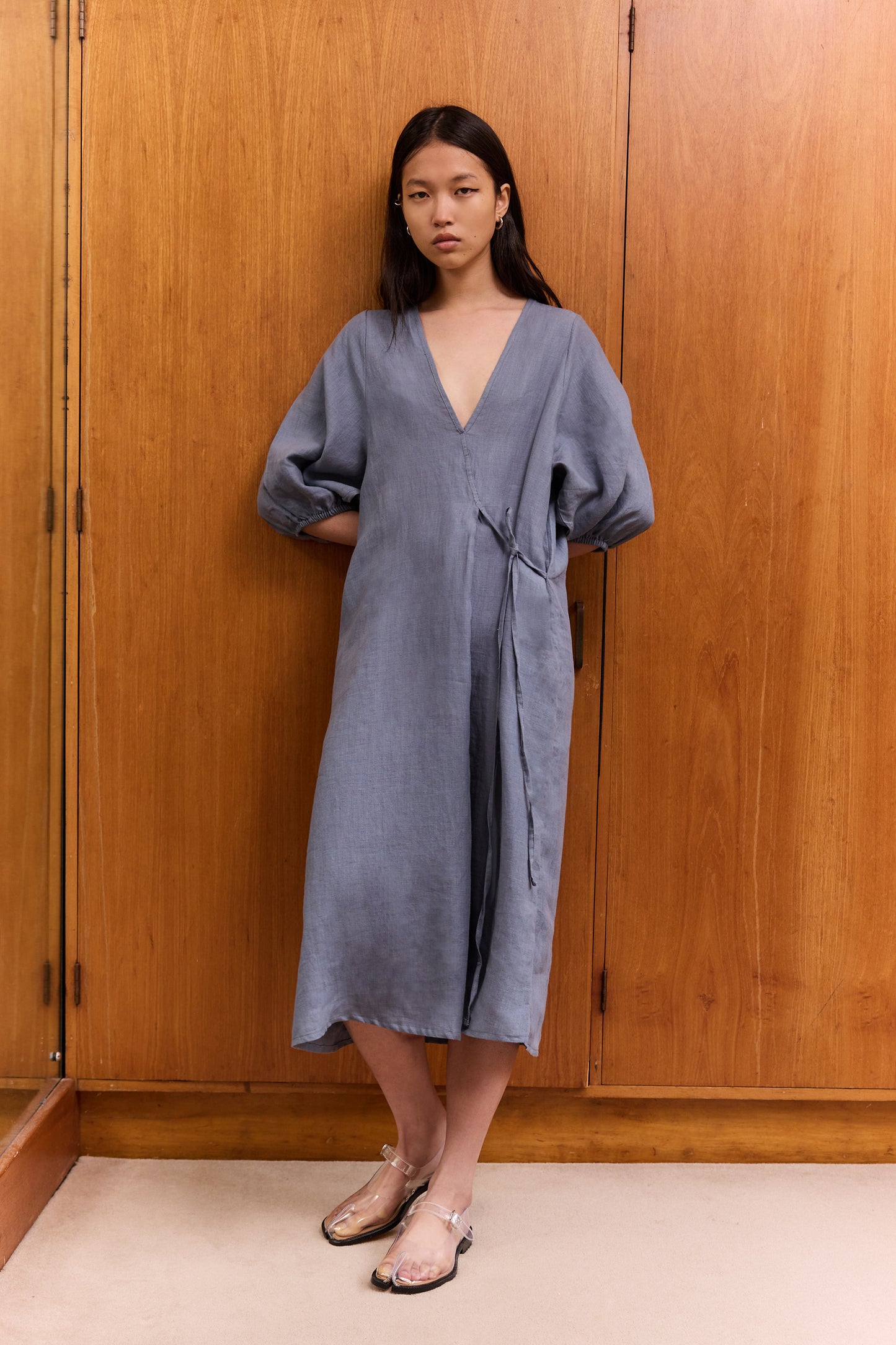 Female model wearing The Crease Bind Dress - Air by Deiji Studios against plain background