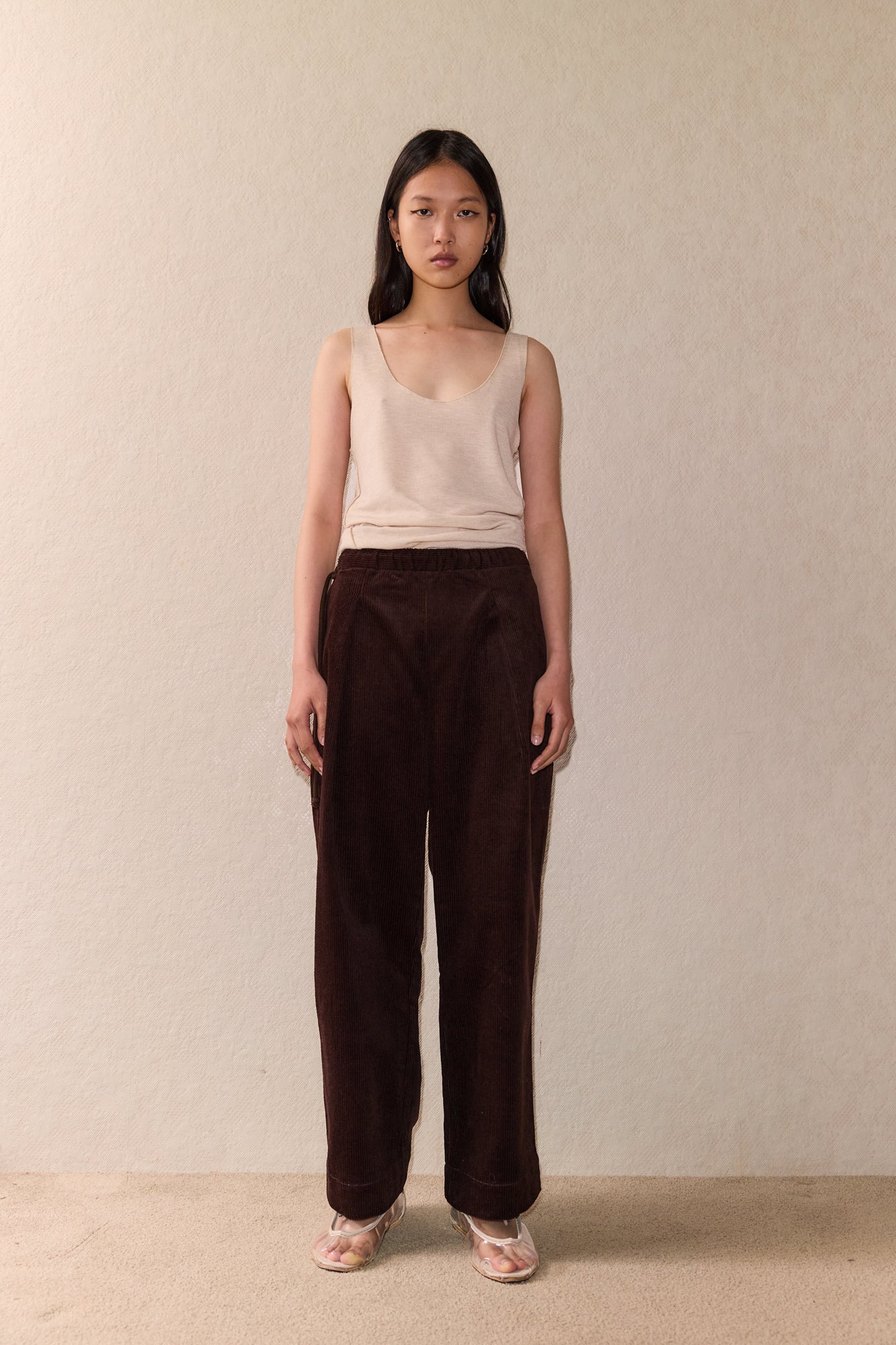 Female model wearing The Straight Cord Pant - Cedar by Deiji Studios against plain background