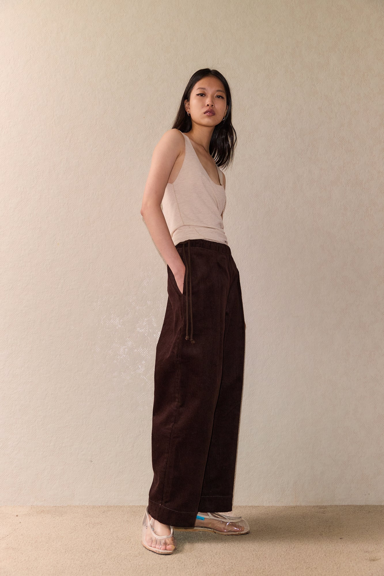 Female model wearing The Straight Cord Pant - Cedar by Deiji Studios against plain background