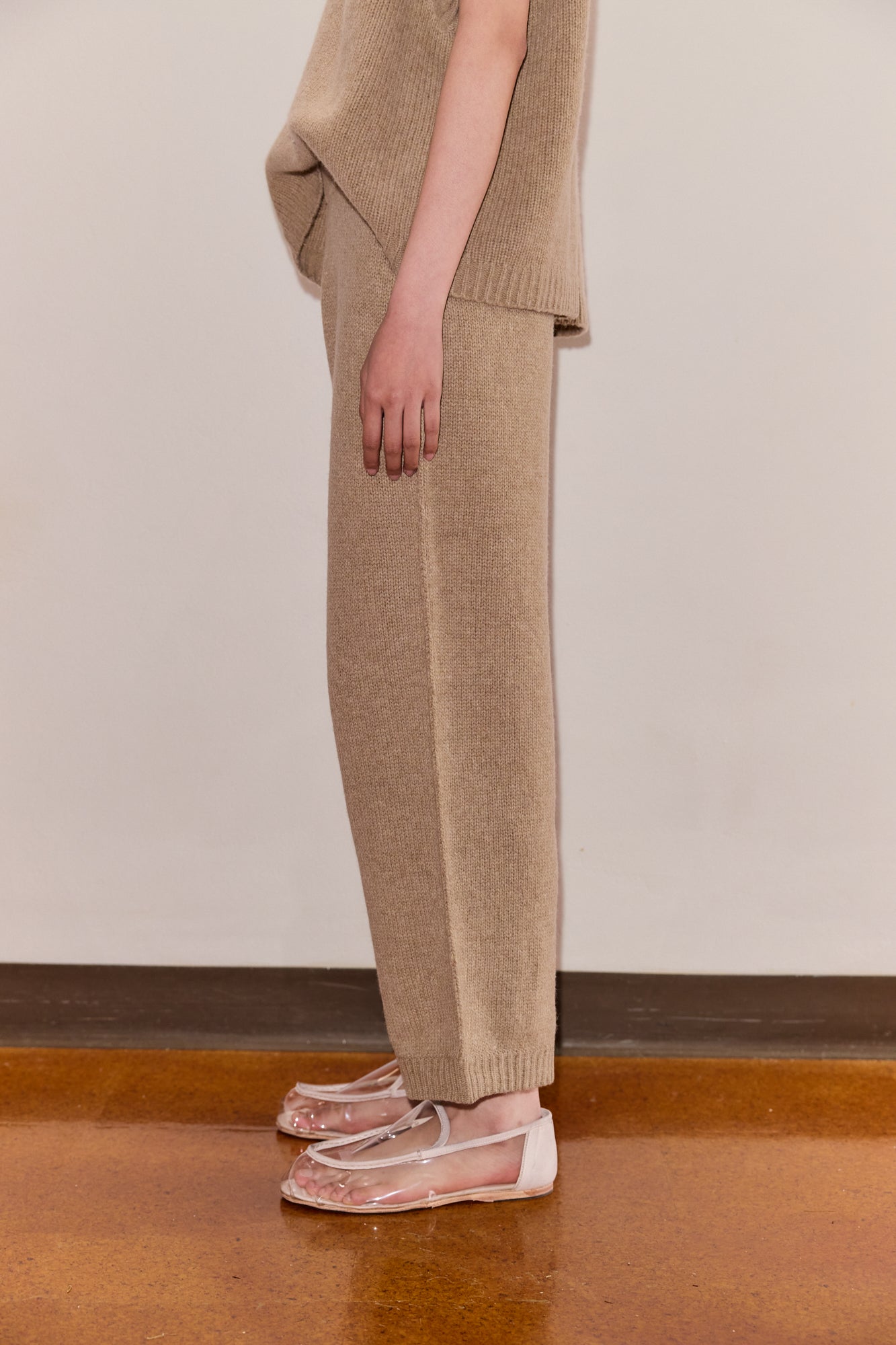 Female model wearing The Seam Knit Pant - Wheat by Deiji Studios against plain background