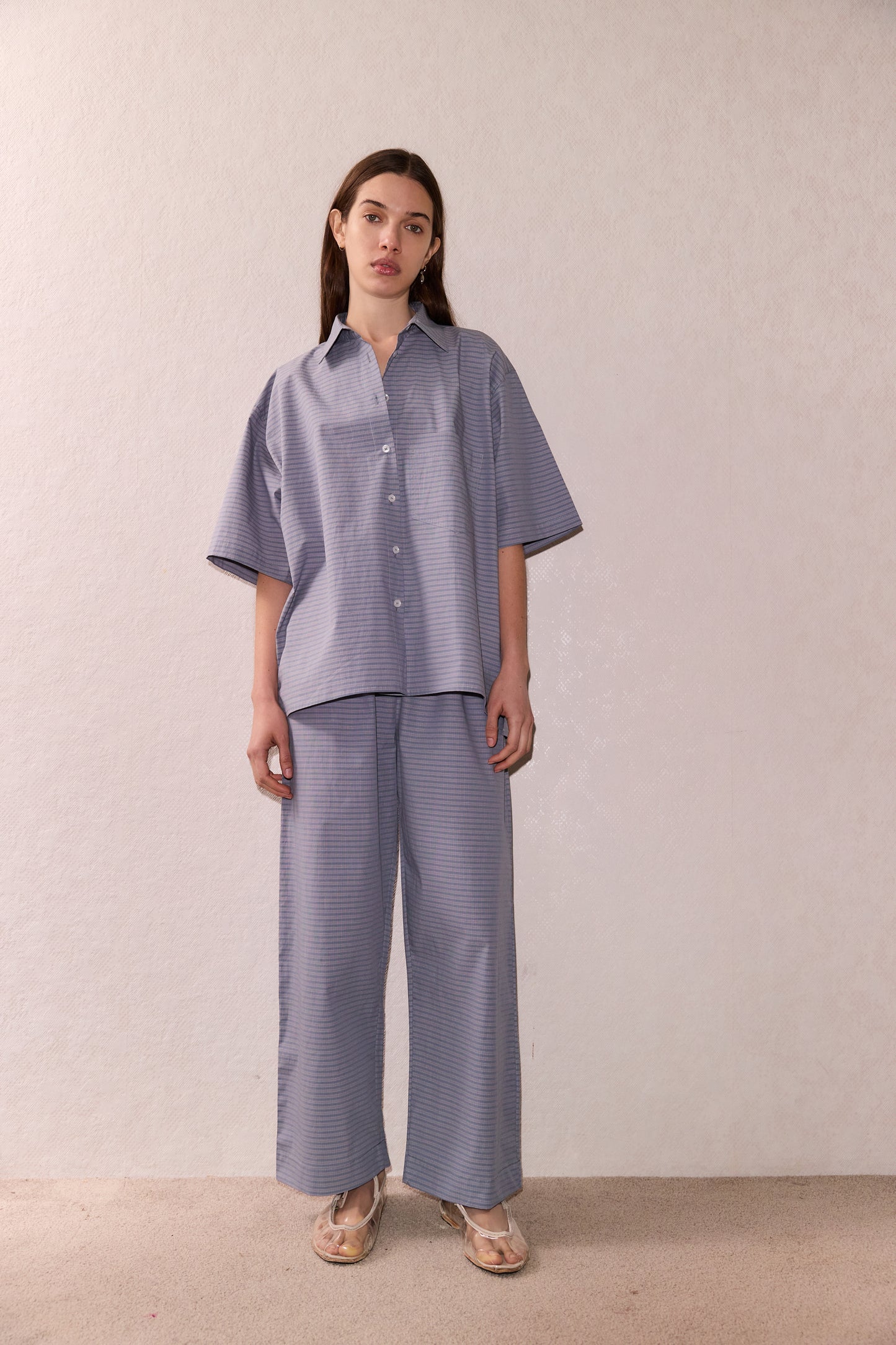 Female model wearing The Short Sleeve Shirt - Pillow Check by Deiji Studios against plain background