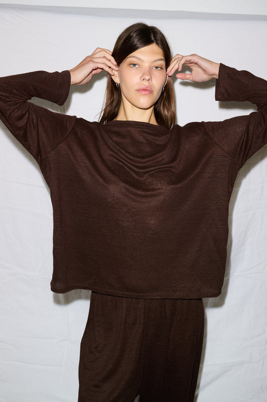 Female model wearing soft long sleeve top - chocolate by Deiji Studios against plain background