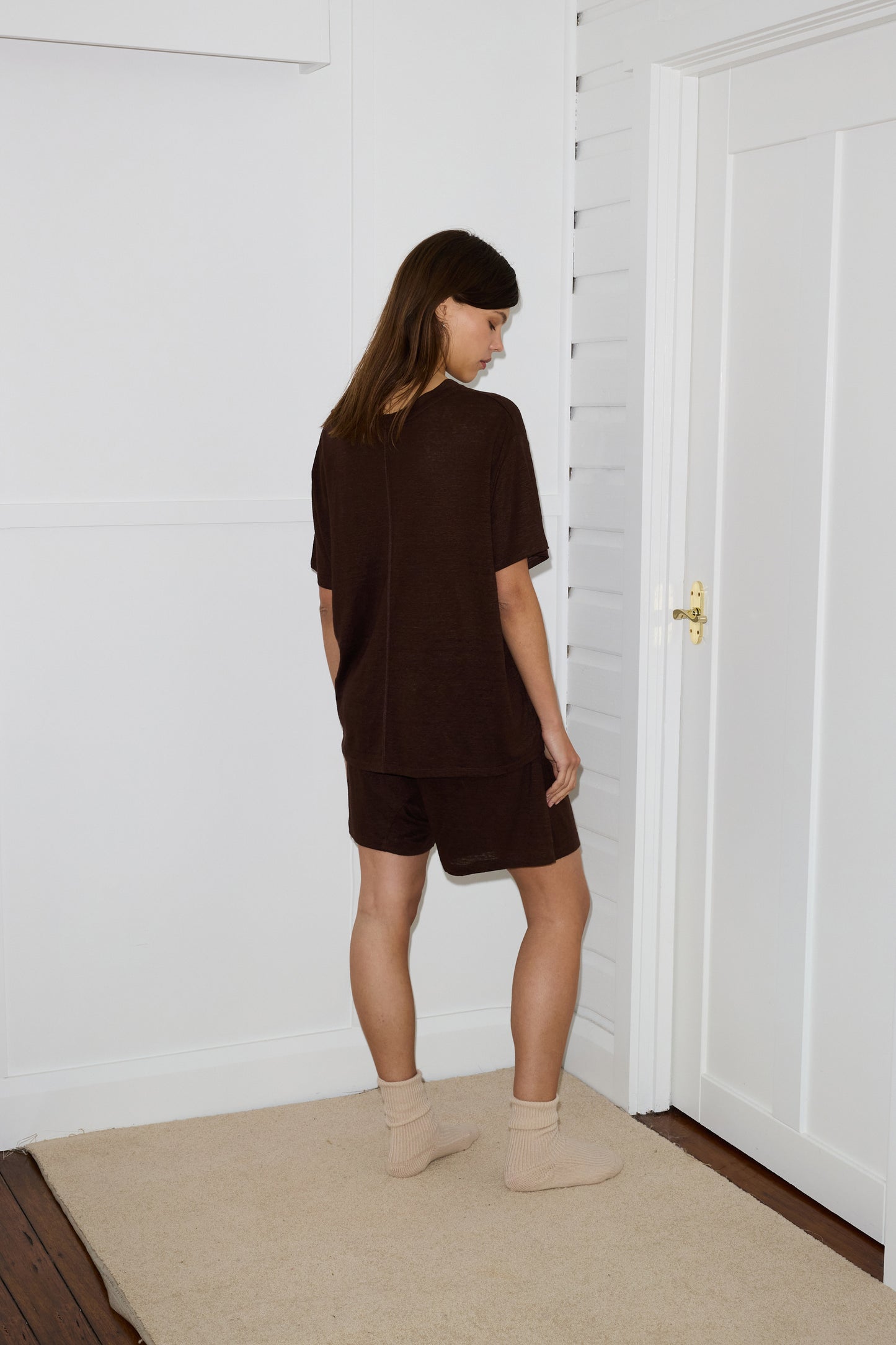 Female model wearing soft short - chocolate by Deiji Studios against plain background