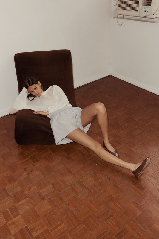 Female model wearing The Boxer - Dream Stripe by Deiji Studios against plain background