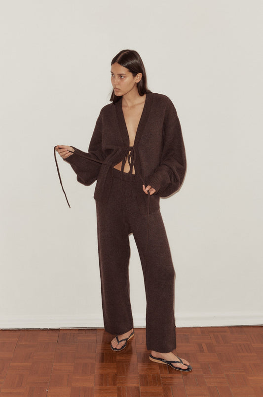 Female model wearing Straight Leg Knit Pants - Plum by Deiji Studios against plain background