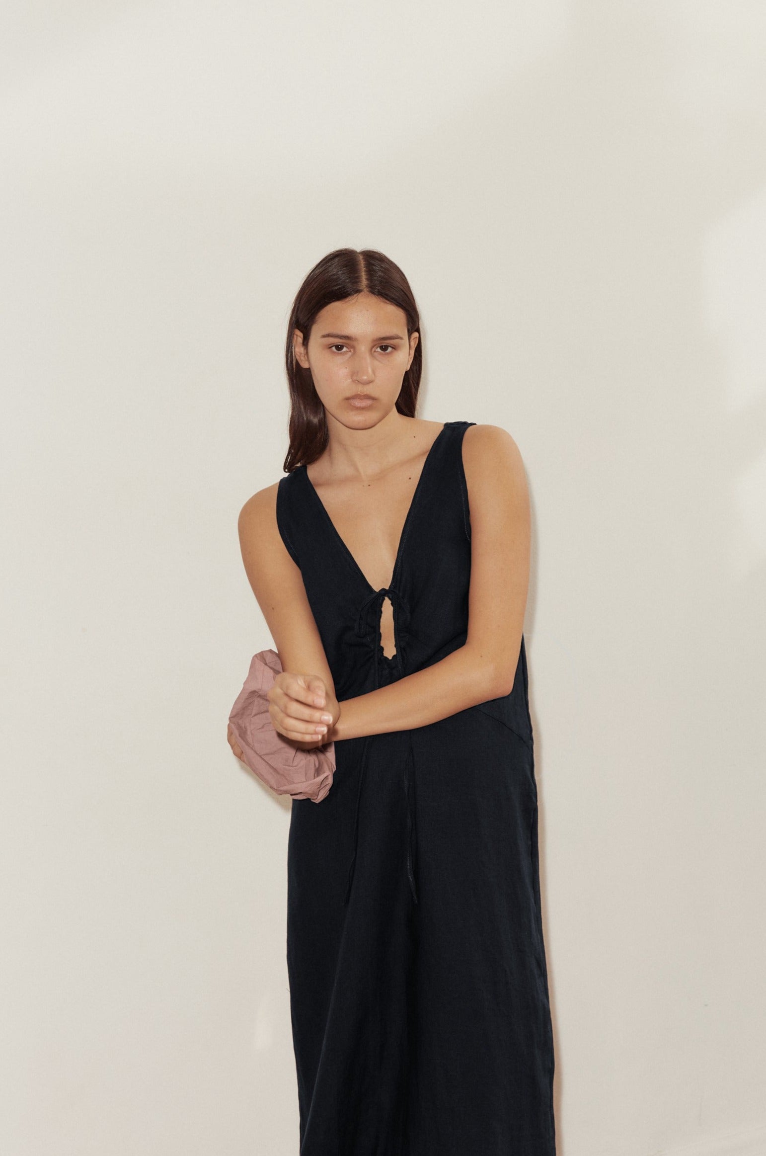Female model wearing Keyhole Dress - Black by Deiji Studios against plain background