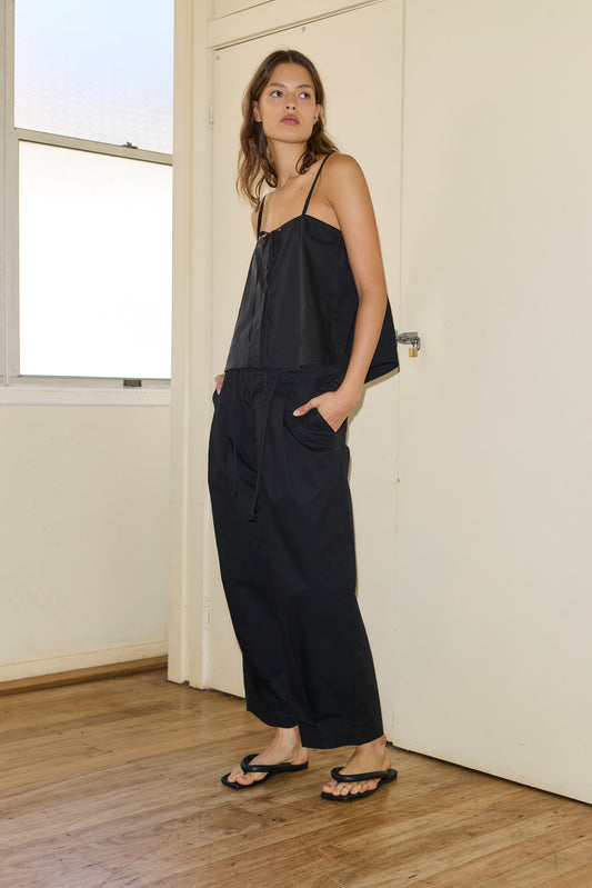 Female model wearing The Cotton Pant - Black by Deiji Studios against plain background