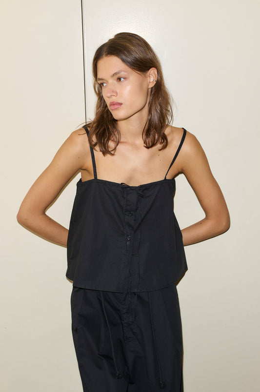 Female model wearing The Placket Strap Top - Black by Deiji Studios against plain background