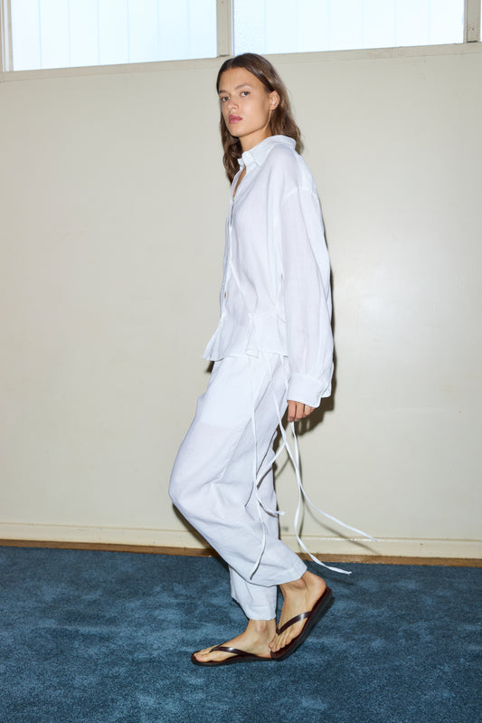 Female model wearing The Off Centre Tie Set - White by Deiji Studios against plain background