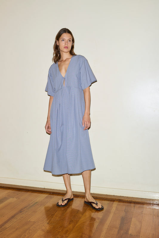 Female model wearing The Square Sleeve Dress - Pillow Check by Deiji Studios against plain background