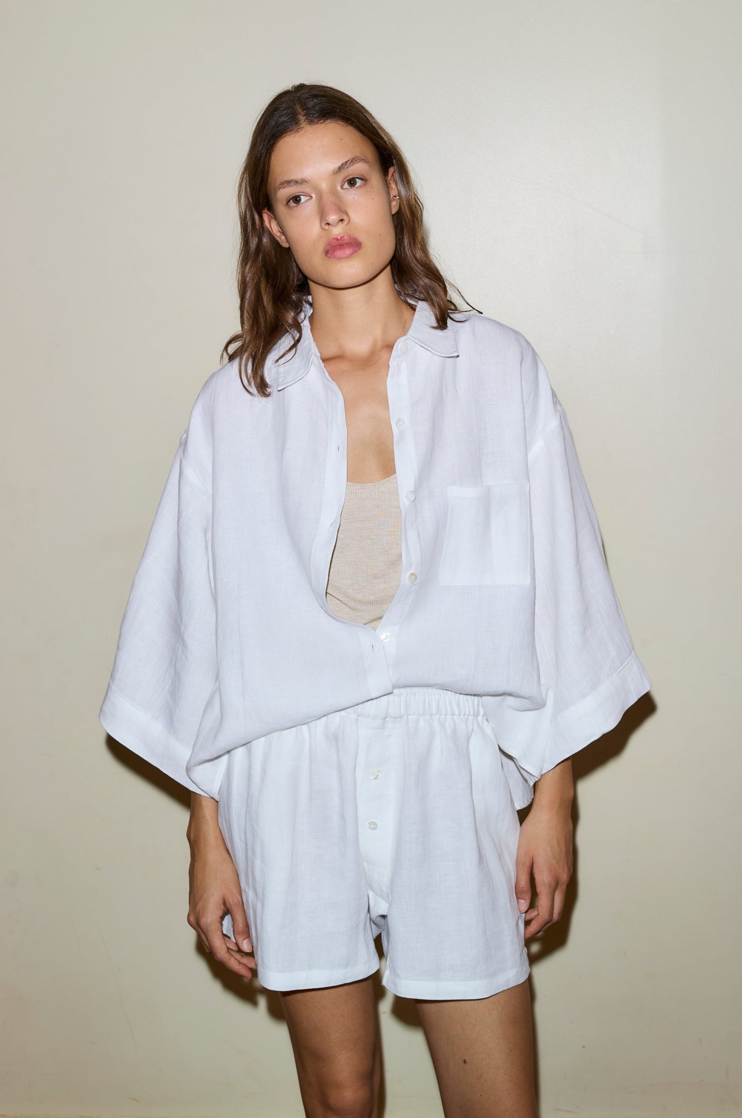 Female model wearing the 03 set - white by Deiji Studios against plain background