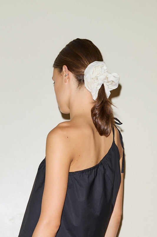 Female model wearing scrunchie - off white by Deiji Studios against plain background