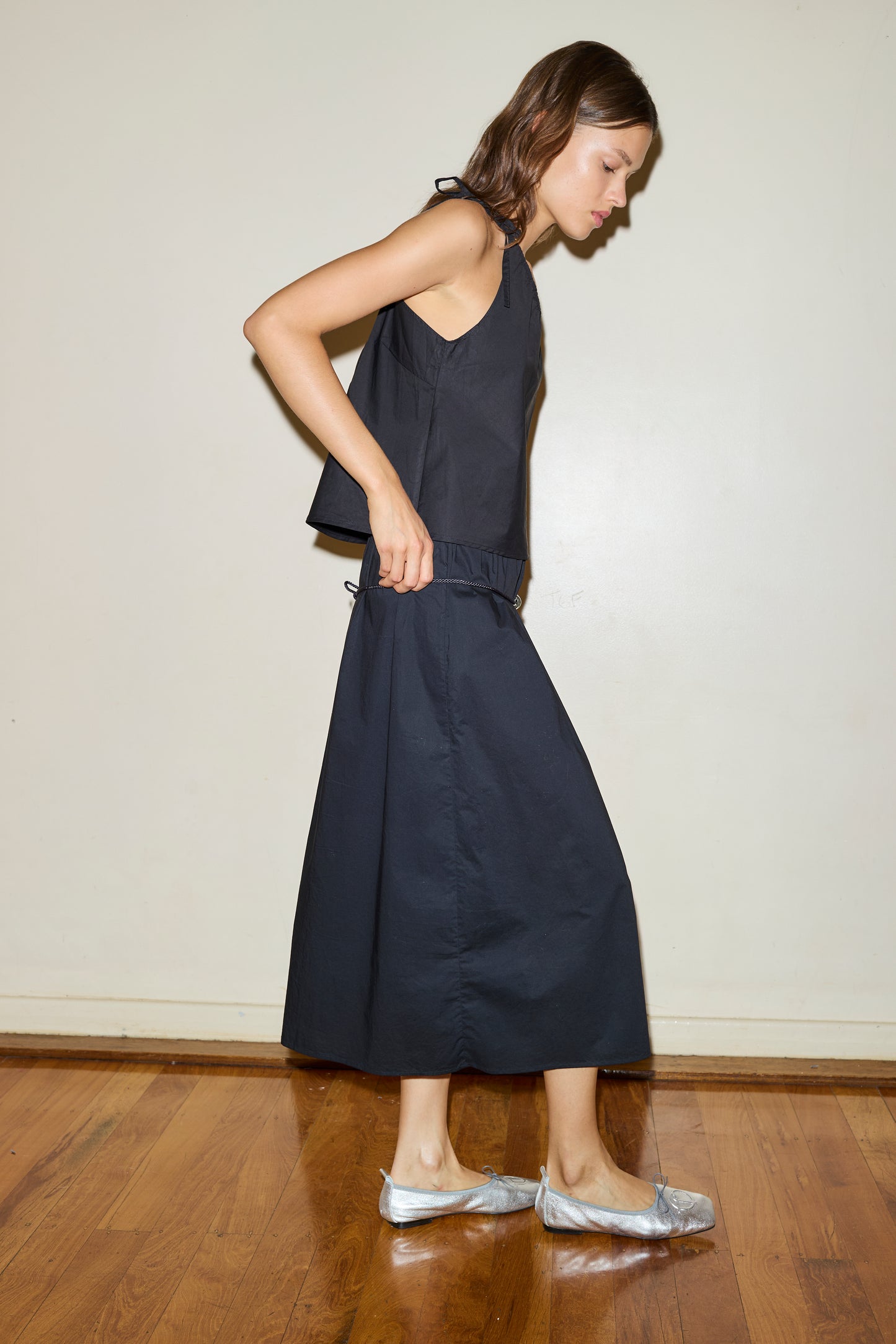 Female model wearing The Multi Strap Top - Black by Deiji Studios against plain background