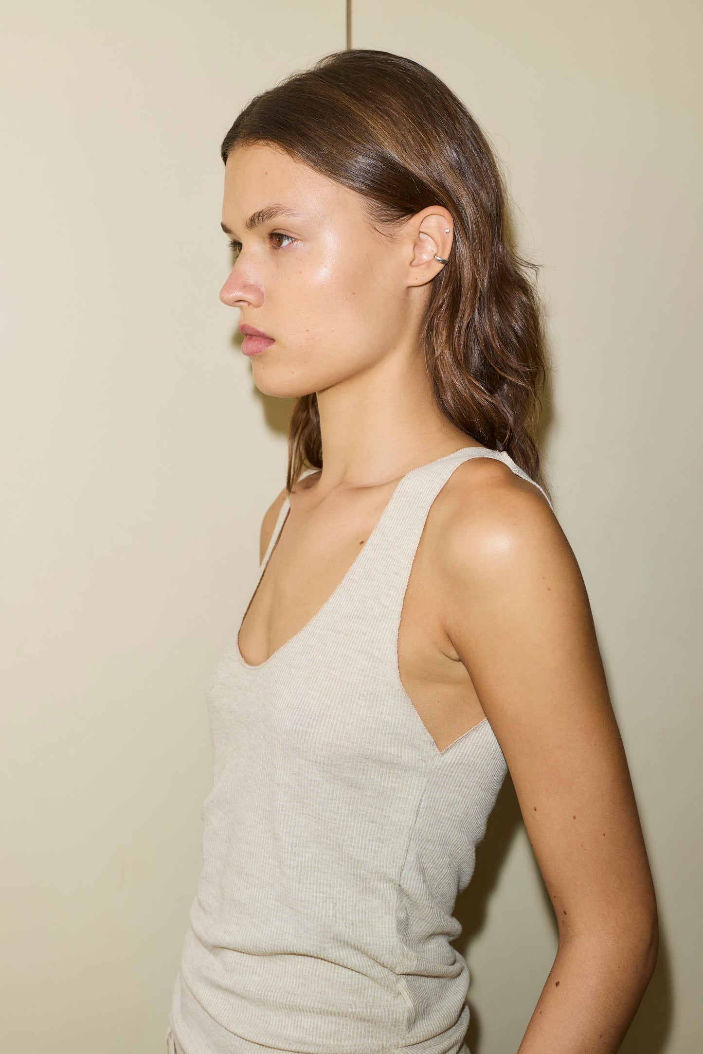 Female model wearing The Knit Tank - Oat by Deiji Studios against plain background