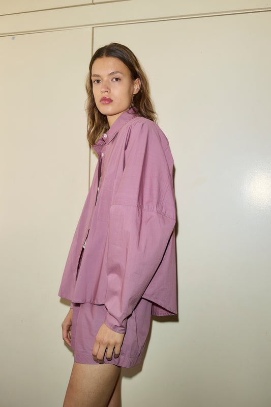 Female model wearing The Curved Shirt - Lavender by Deiji Studios against plain background
