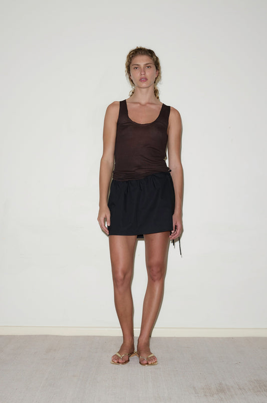 Female model wearing Block Mini Skirt - Black by Deiji Studios against plain background