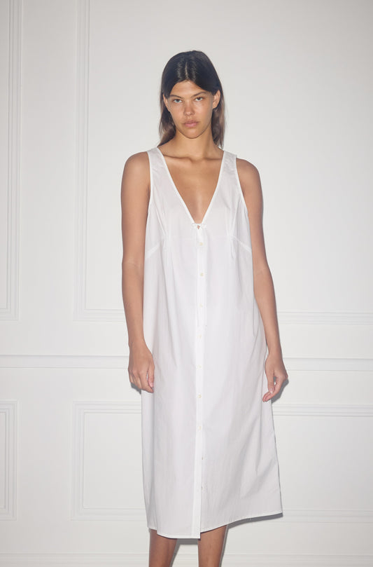 Female model wearing Tuck Tie Dress - White by Deiji Studios against plain background