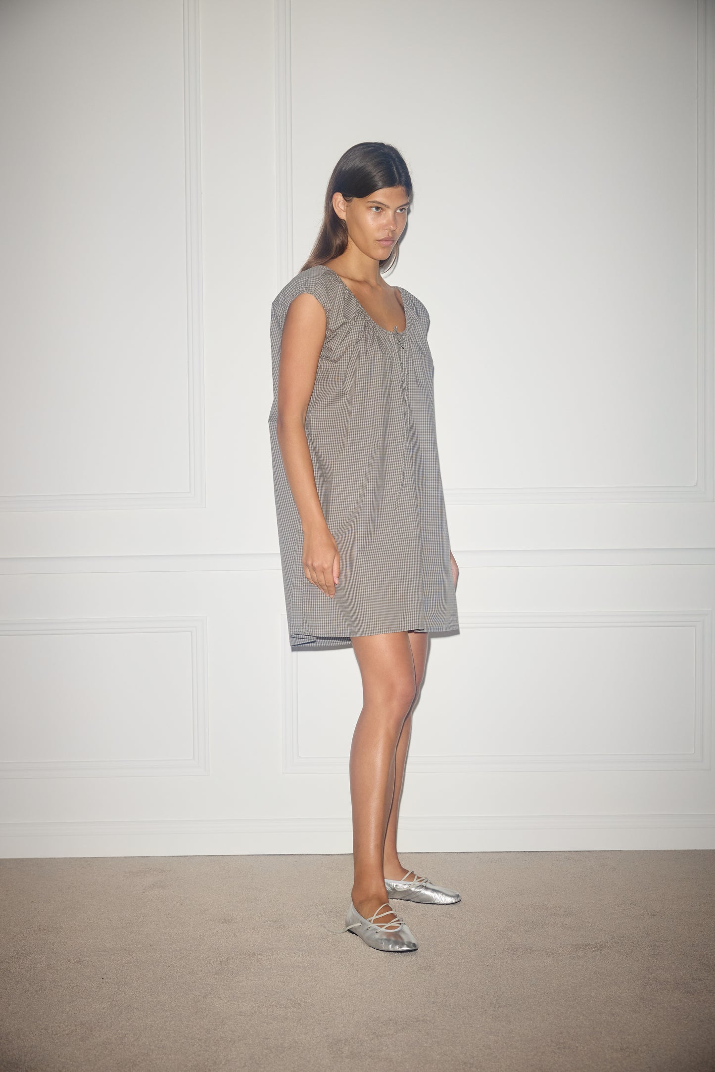 Female model wearing Capped Sleeve Dress - Khaki Check by Deiji Studios against plain background