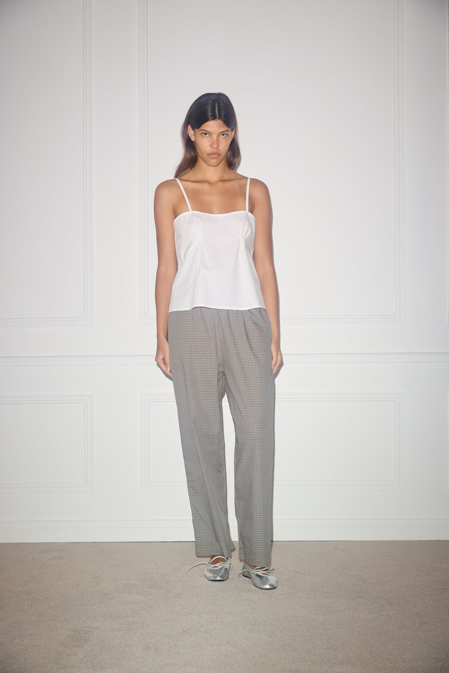 Female model wearing Pleat Top - White by Deiji Studios against plain background