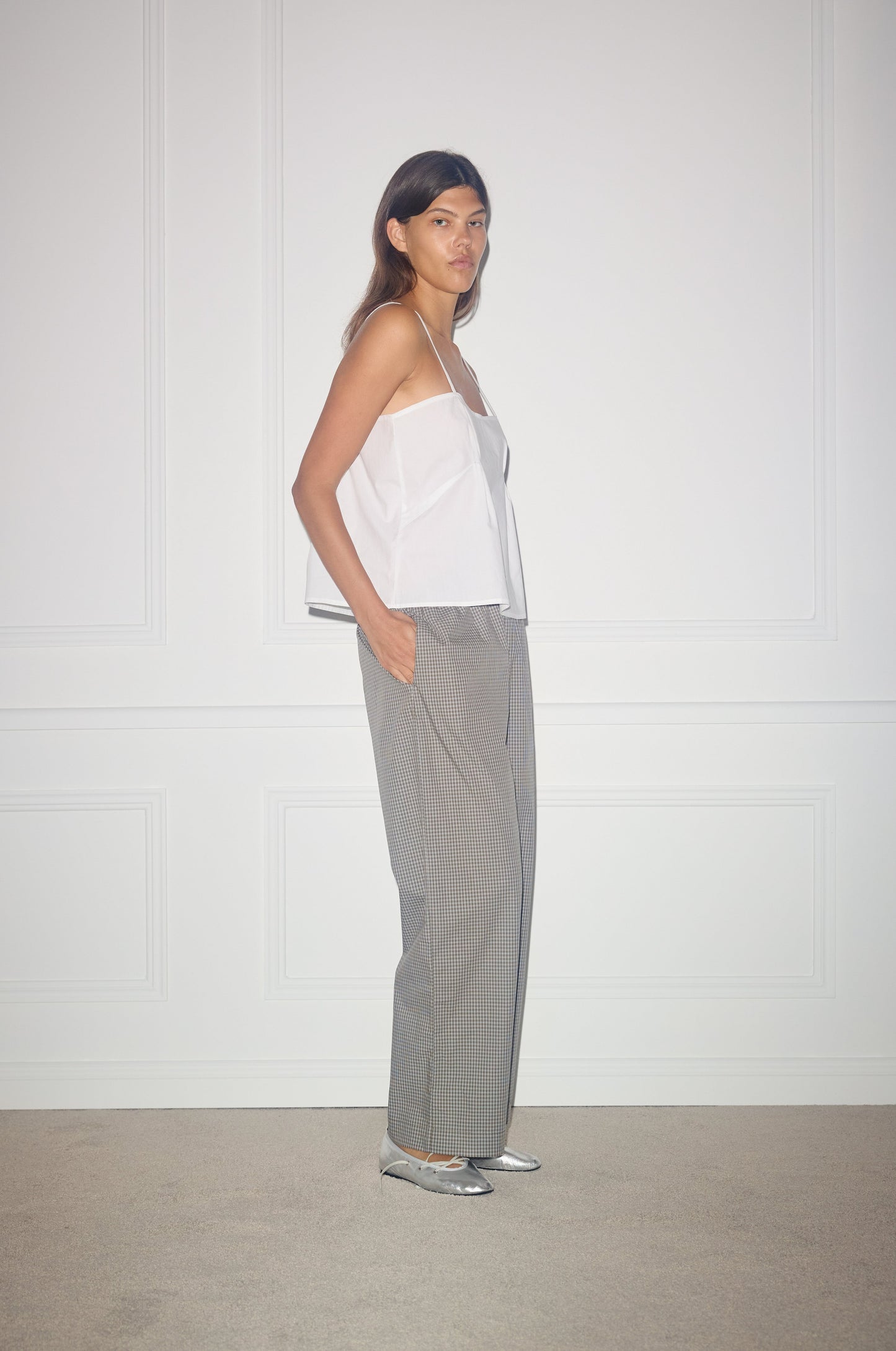 Female model wearing Ease Trouser - Khaki Check by Deiji Studios against plain background