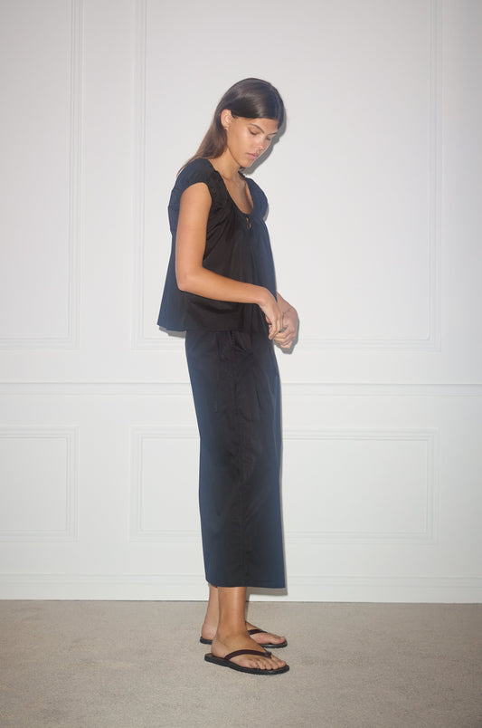 Female model wearing Pintuck Skirt - Black by Deiji Studios against plain background