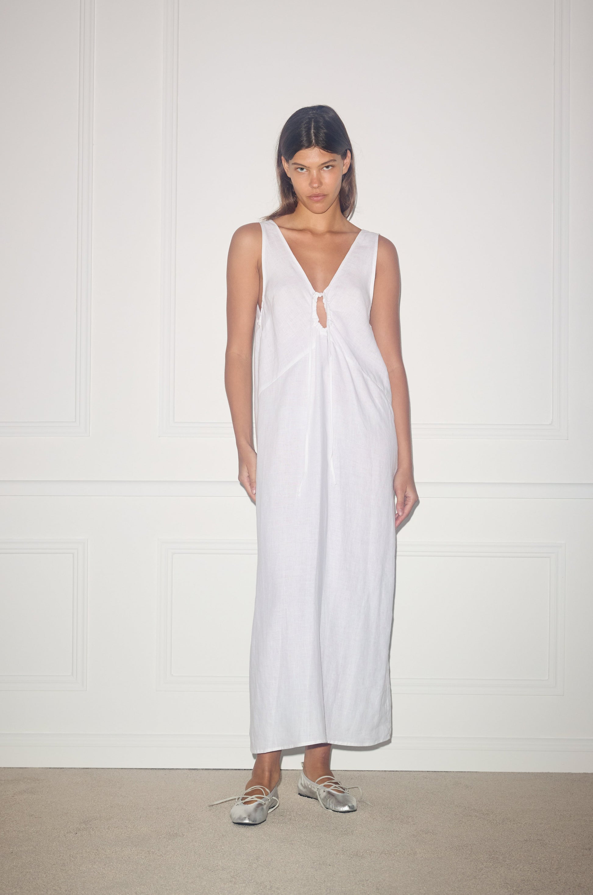 Female model wearing Keyhole Dress - White by Deiji Studios against plain background