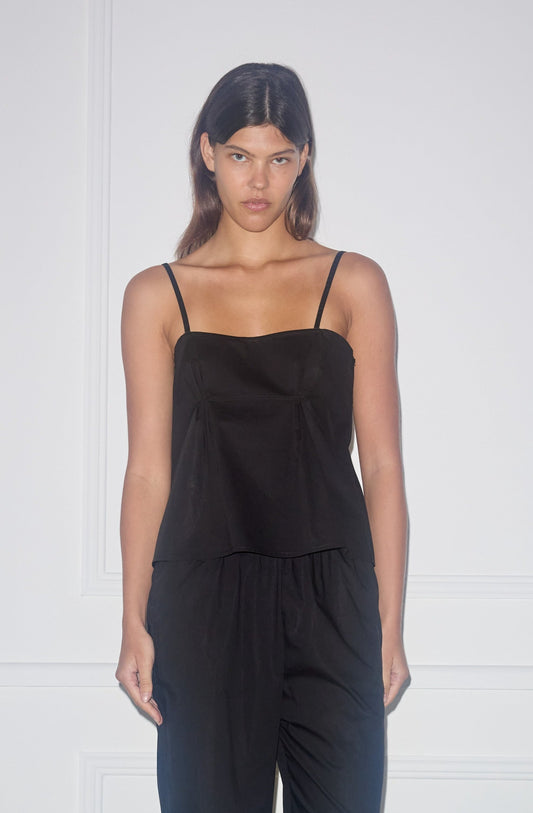 Female model wearing Pleat Top - Black by Deiji Studios against plain background