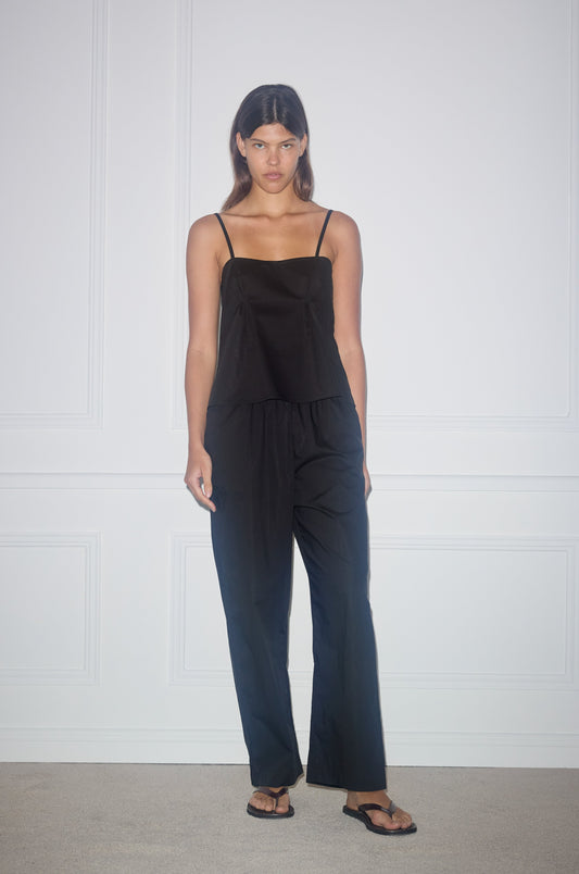 Female model wearing the ease trouser - black by Deiji Studios against plain background