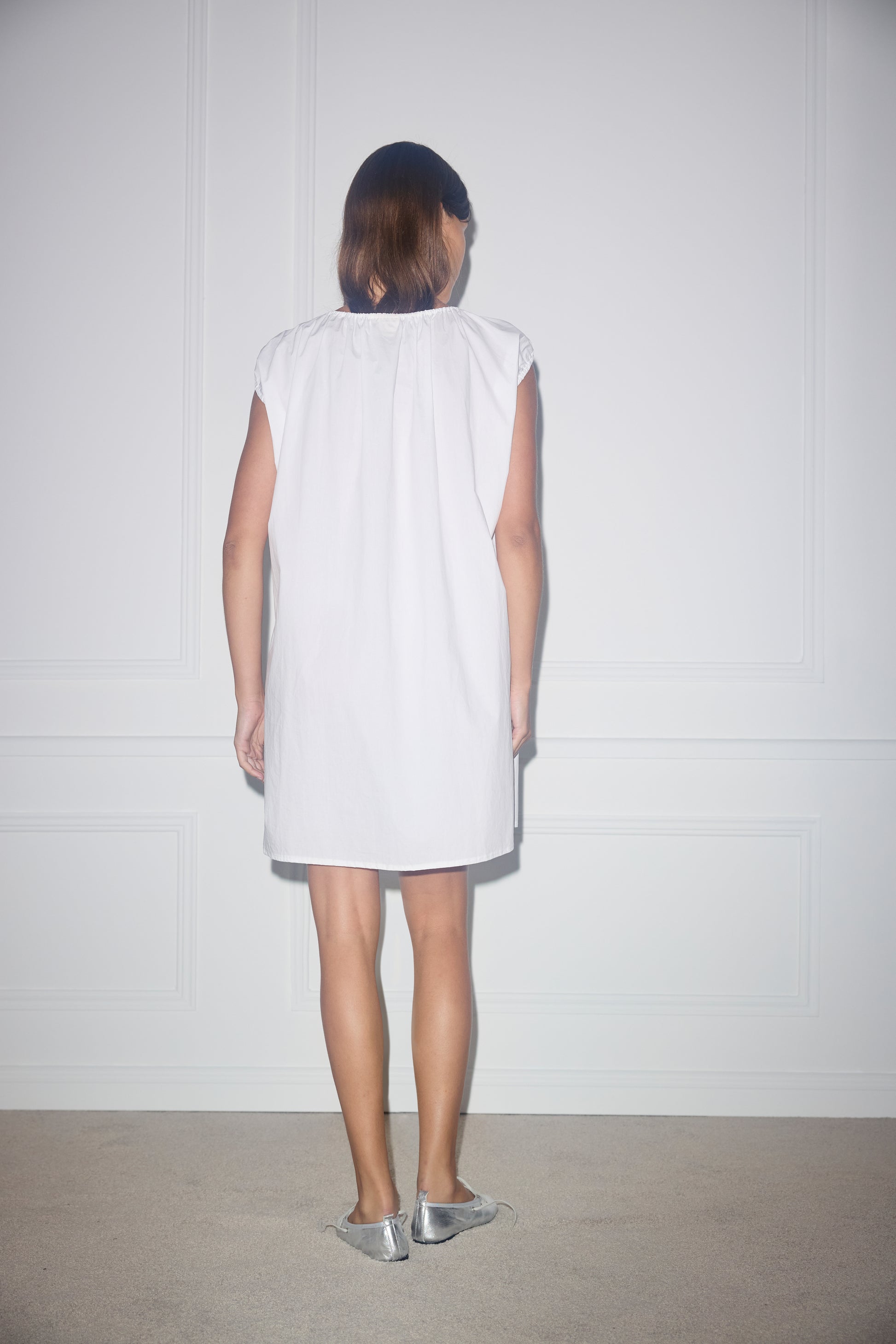 Female model wearing Capped Sleeve Dress - White by Deiji Studios against plain background