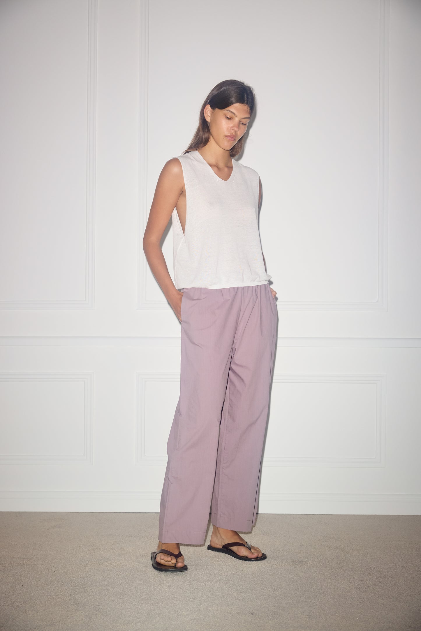 Female model wearing Ease Trouser - Mauve by Deiji Studios against plain background