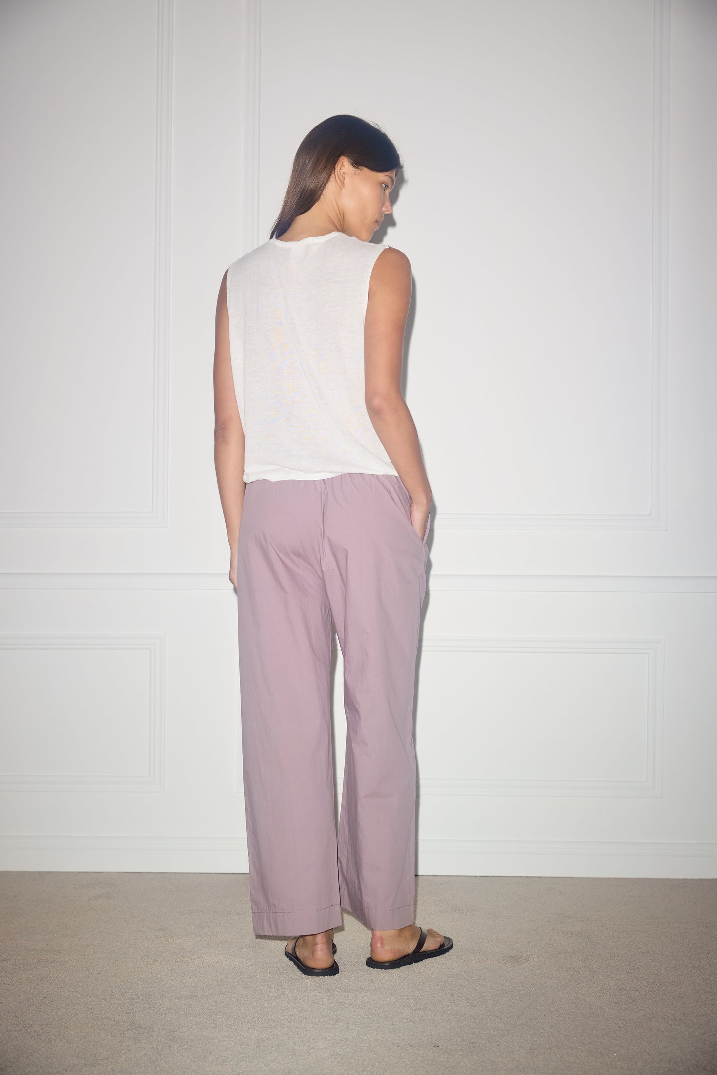 Female model wearing Ease Trouser - Mauve by Deiji Studios against plain background