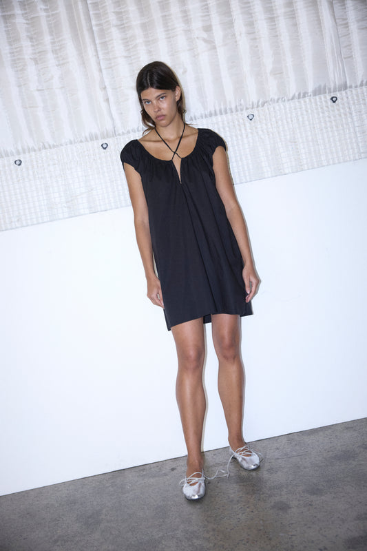 Female model wearing Capped Sleeve Dress - Black by Deiji Studios against plain background