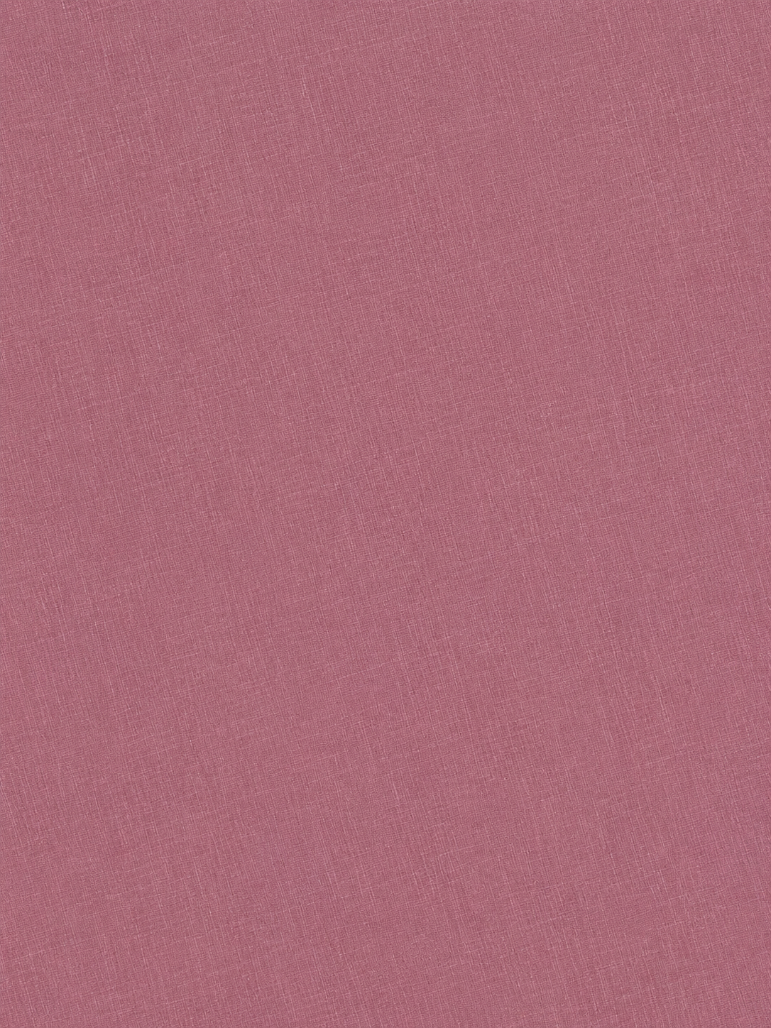 A close-up view of a textured pink fabric surface, displaying fine, intersecting threads and a subtle linen-like weave pattern—evocative of the refined materials featured in Deiji Studios’ signature pieces, like the Half Halter - Brick.