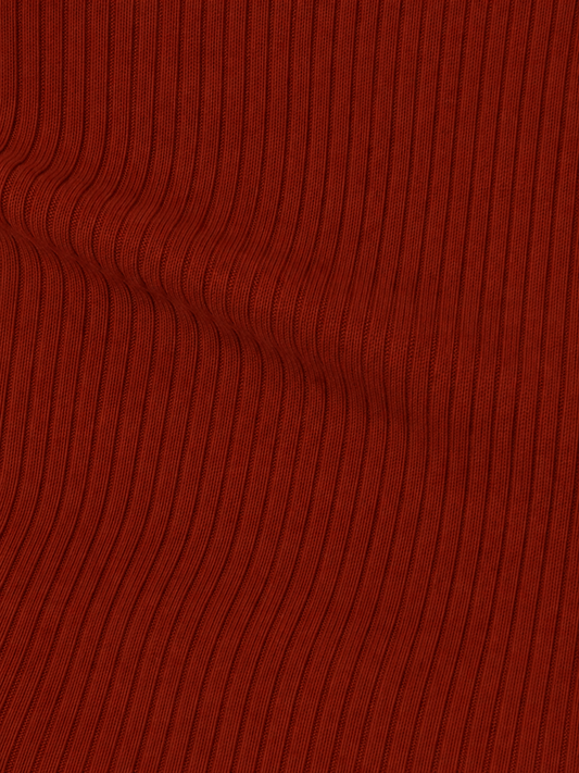 Close-up of the ribbed, textured red fabric from the Half Top - Red, featuring vertical lines and a slight wavy distortion near the left side.