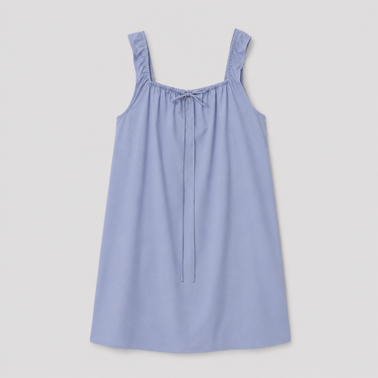The Bow Dress - Iris by Deiji Studios is a sleeveless, light blue mini dress with wide straps, a gathered neckline, and a front tie detail, shown laid flat on a white background.